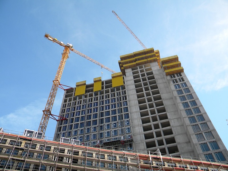 Building under construction and by cranes