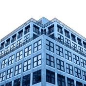 A residential building in trendy classic blue color with cut out sky with white isolated background.
